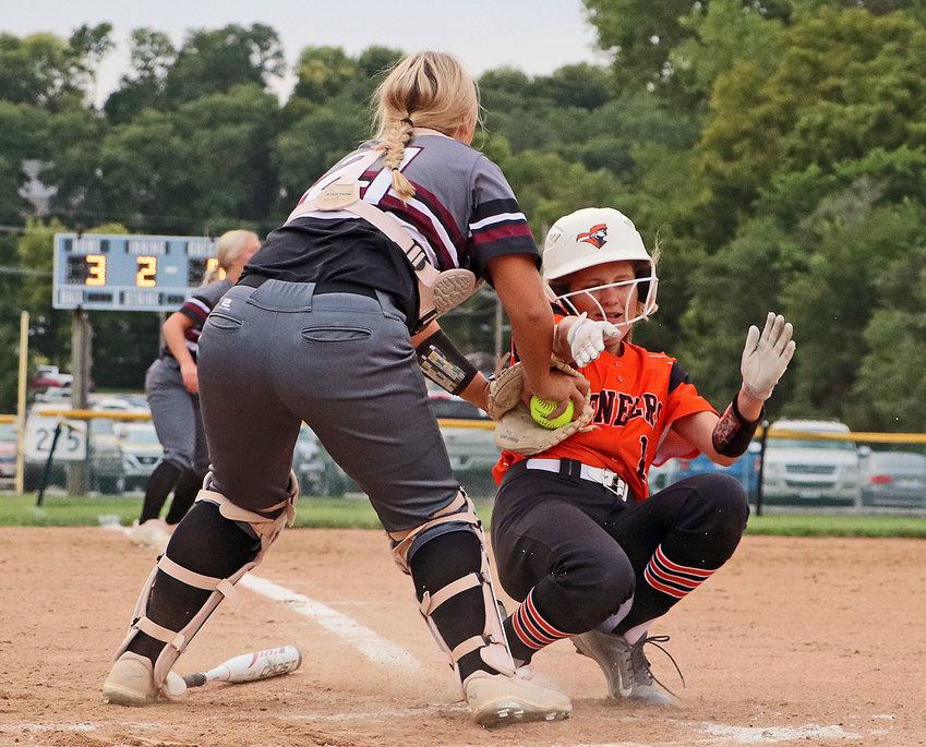 Arlington catcher Cadie Robinson, left, tags the Pioneers' Sammie Ladwig out at home plate Thursday in Fort Calhoun.