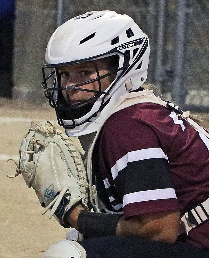 Arlington senior Cadie Robinson looks to the dugout for the pitch call Tuesday at Two Rivers Sports Complex.