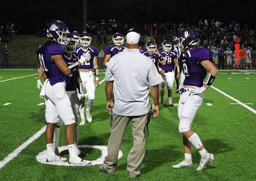 Blair coach Bryan Soukup, middle, meets with the Bears during a timeout Friday at Krantz Field.