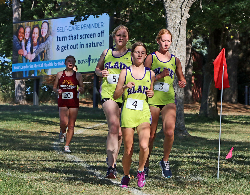 Blair's Chloe Schrick, from left, Isabella Matney and Ella Donner run in a pack Thursday at Boys Town.