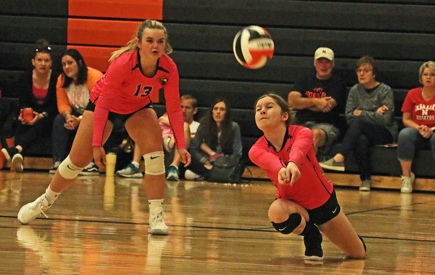 The Pioneers' Ruby Garmong, right, lunges for the ball as teammate Tilden Nottlemann lends support Saturday at Fort Calhoun High School.