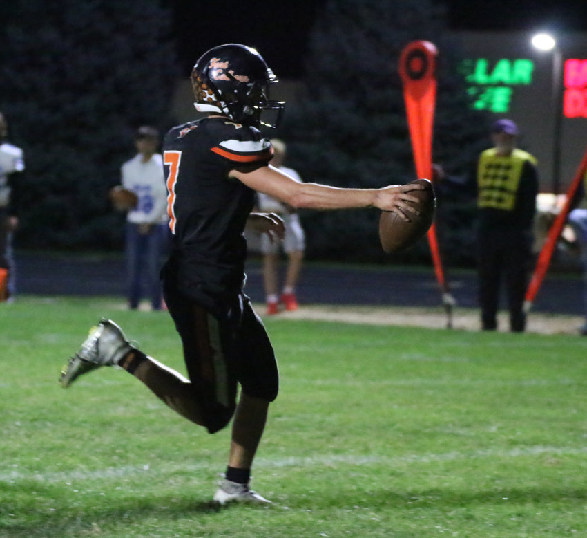 Fort Calhoun quarterback Austin Welchert holds the ball out as he crosses the goal line during the Pioneers' touchdown late in the fourth quarter.