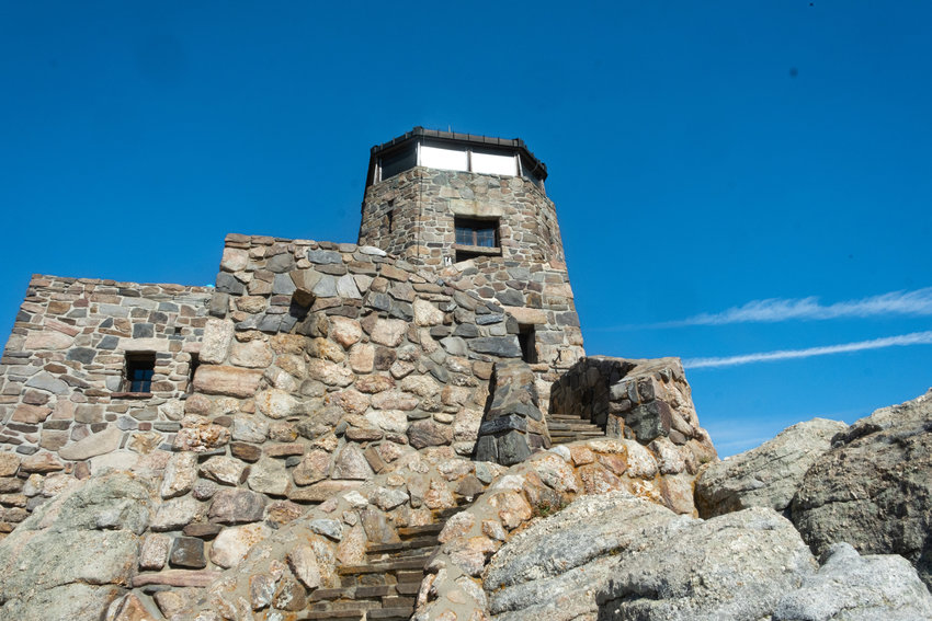 A stone fire tower constructed by the Civilian Conservation Corp in 1935 crowns the summit of Black Elk Peak