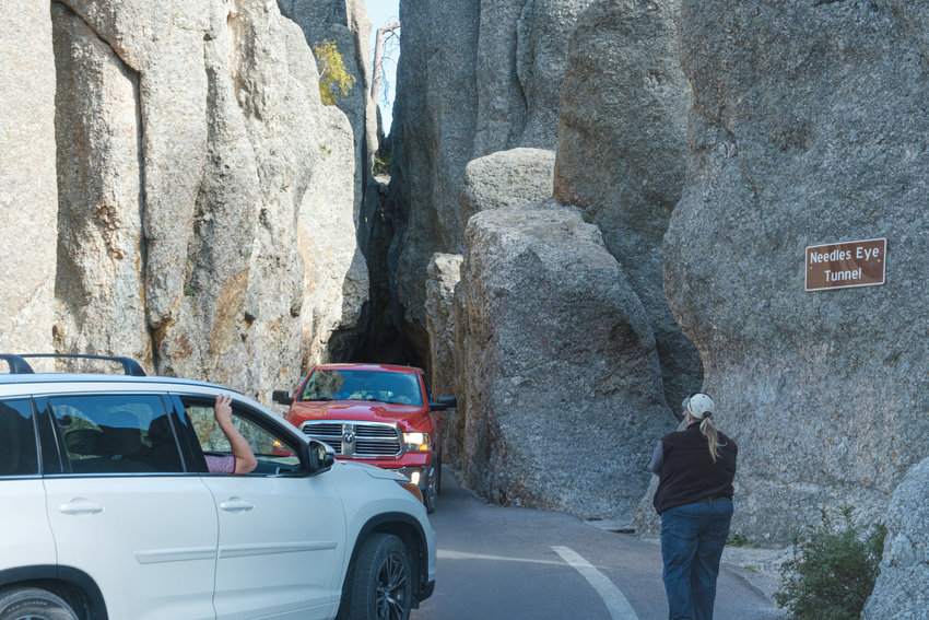 Cars jockey for position and take turns passing through Needles Eye Tunnel in Custer State Park.