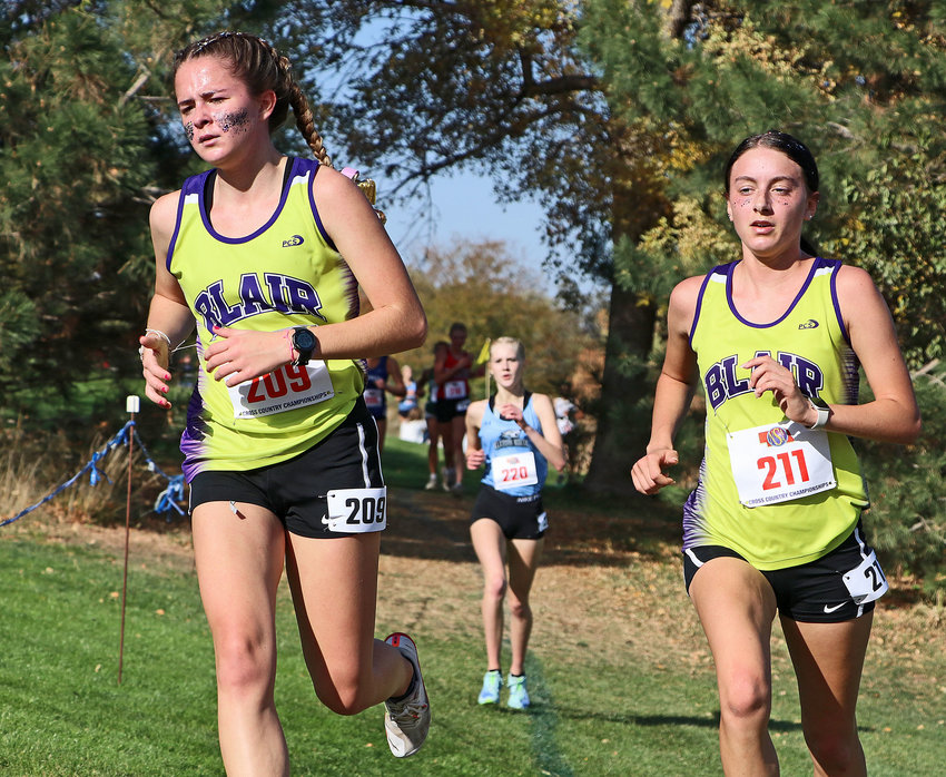 Blair runners Allie Czapla, left, and Reece Ewoldt compete Friday at Kearney Country Club.