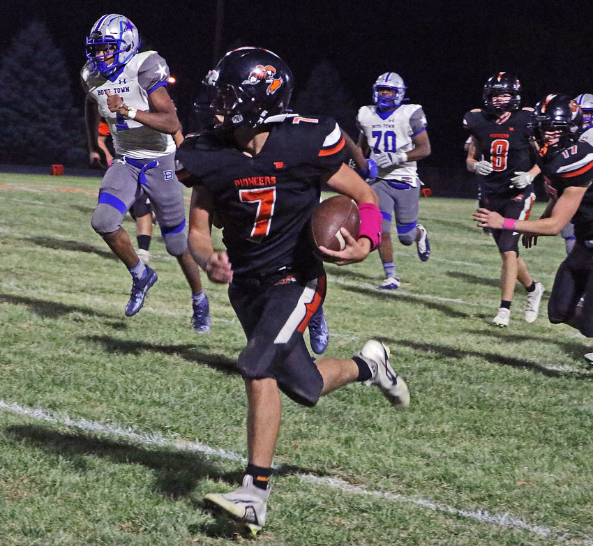 Pioneers quarterback Austin Welchert races down the sideline for a fourth-quarter first down Friday against Boys Town at Fort Calhoun High School.