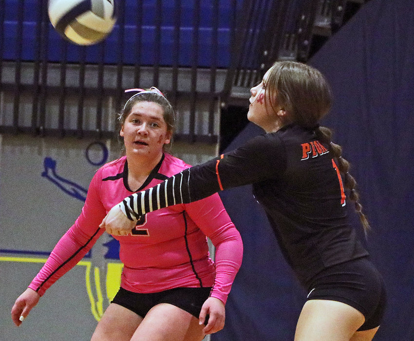 Fort Calhoujn's Mollie Dierks, left, watches as teammate Ruby Garmong passes the ball Thursday at Logan View.