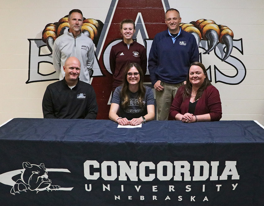 Arlington senior Keelianne Green signed to compete with the Concordia Bulldogs in college Monday. She was joined by her parents Goeffrey and Sheri, and her coaches — Steven Gubbels, back row, from left, Michaela Curran and Concordia's Matt Beisel.