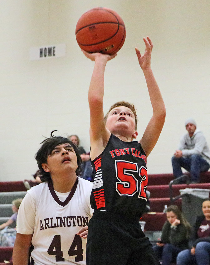 Fort Calhoun's Aiden Husk, right, puts up a shot as the Eagles' Christian Flores defends Tuesday at Arlington High School.