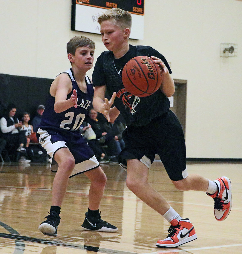 Paxton Wagner, right, of the Fort Calhoun Youth Sports Organization (FCYSO) sixth-grade basketball team dribbles while defended by Blair Basketball Club Purple's Cole McCarty on Saturday during the Storm the Fort Tournament at FCHS. Boys and girls teams in grades 2-6 competed during the two-day event, which was played in Fort Calhoun's high school and elementary gyms.