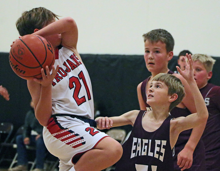 Brody Stork, right, of the sixth-grade Arlington Eagles plays defense against the Jr. Trojans Red on Saturday at Fort Calhoun High School. Multiple Arlington youth basketball teams participated in the Storm the Fort tournament there.