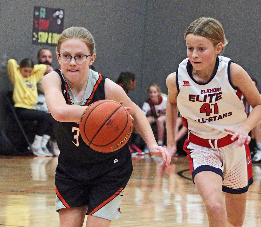 Fort Calhoun fifth-grader Claire Husk, left, dribbles up the floor Saturday at Fort Calhoun Elementary.
