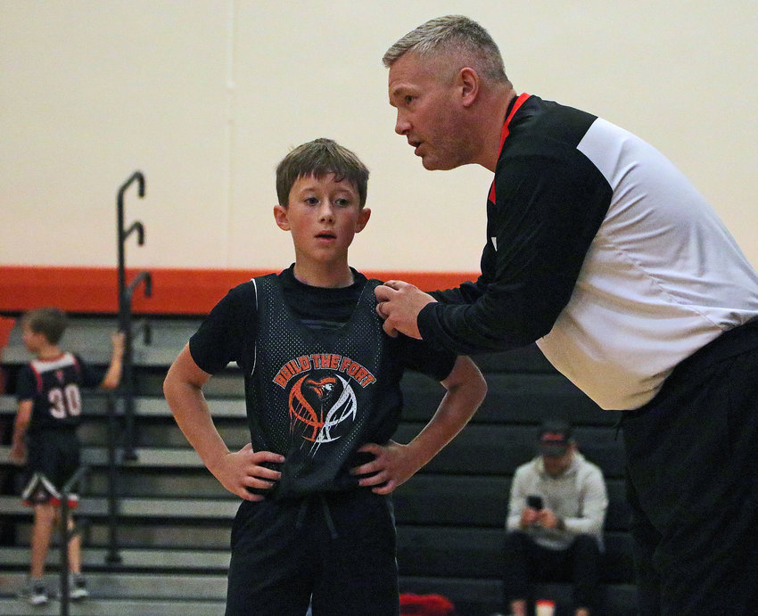 Fort Calhoun sixth-grader Michael Dennis, left, gets some coaching from Drew Wagner on Saturday at FCHS.