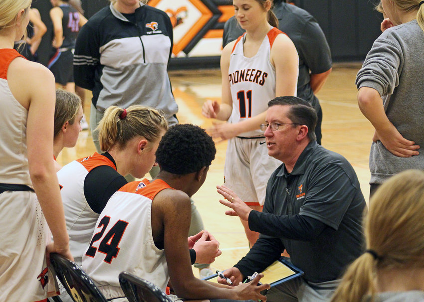 Pioneers coach Marty Plum, right, speaks with his team Monday at Fort Calhoun High School.