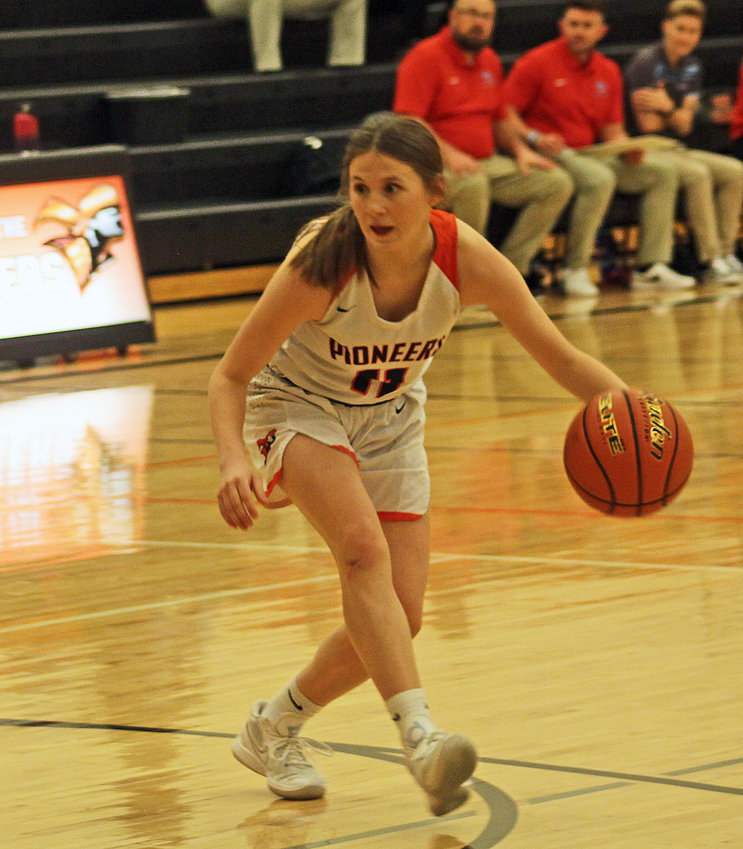 The Pioneers' Maddy Tinkham dribbles inside the 3-point line Monday at Fort Calhoun High School.