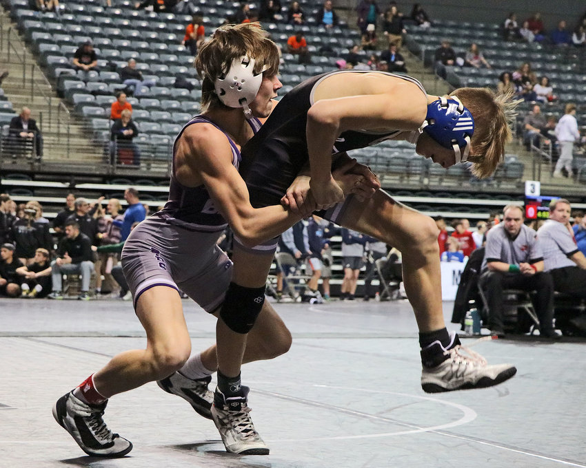 Roman Clouse of Gardner-Edgerton, right, attempts to escape Blair's Hudson Loges on Friday at the Mid-America Center.