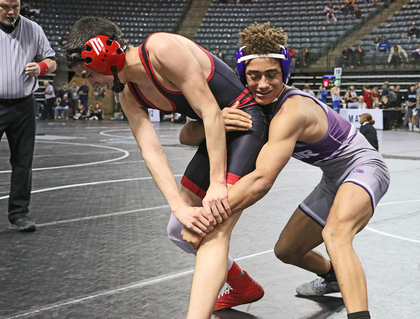 Blair's Tyson Brown, right, keeps his grip on Amir Rasulov of Omaha Westside on Friday at the Mid-America Center.