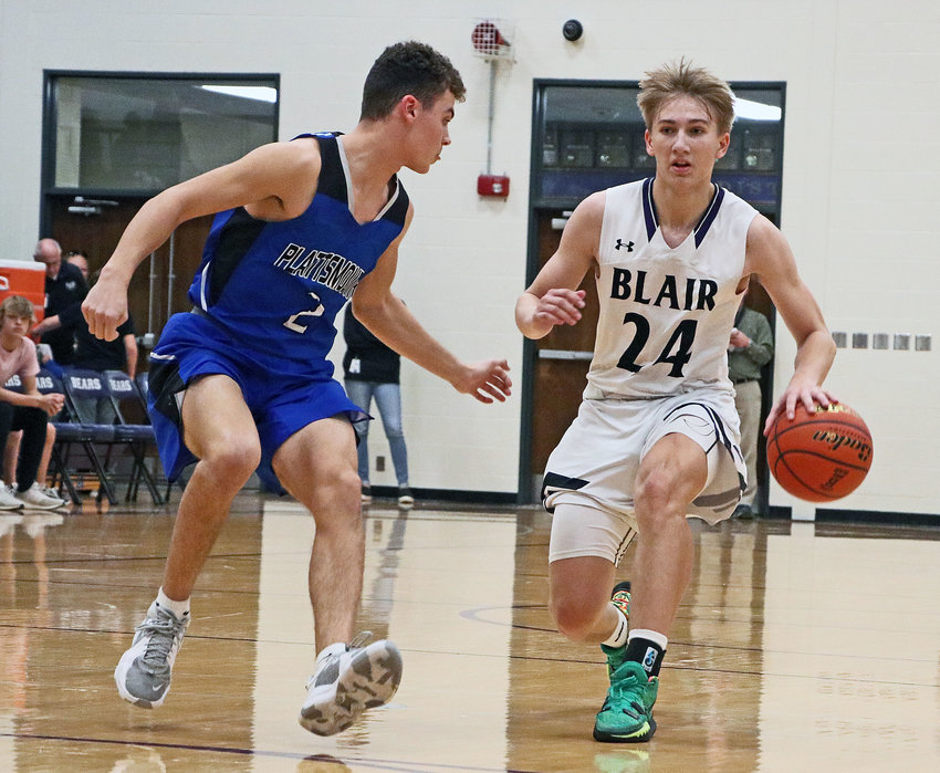 The Bears' Greyson Kay, right, puts on the brakes dribbling against Plattsmouth on Friday at Blair High School.