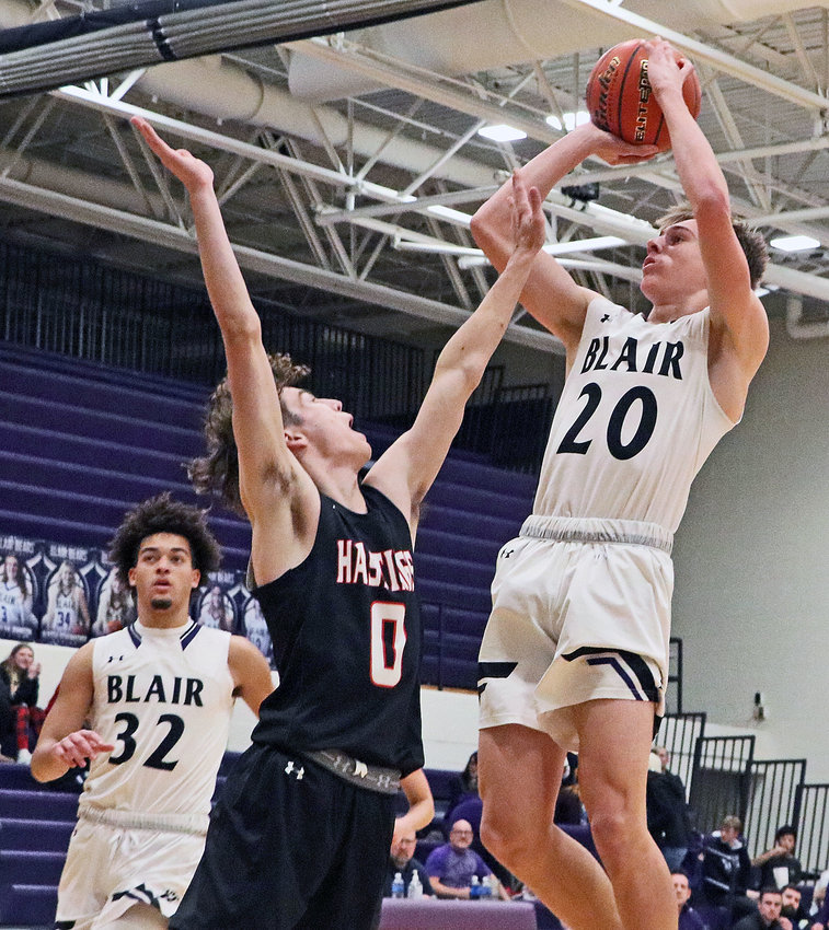 The Bears' Crayton Macholan, right, scores a bucket in the lane over Hastings' Aaron Nonneman on Tuesday at Blair High School.