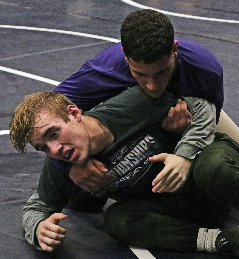 Nathan Boswell, left, works to escape teammate Yoan Camejo on Dec. 28 during a Blair High School wrestling practice.