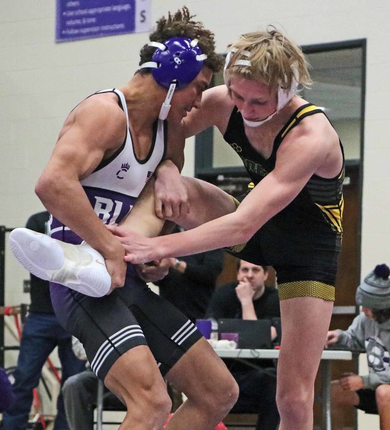 The Bears' Tyson Brown, left, grabs the leg of Gretna's Kale Vice on Tuesday at Blair High School.