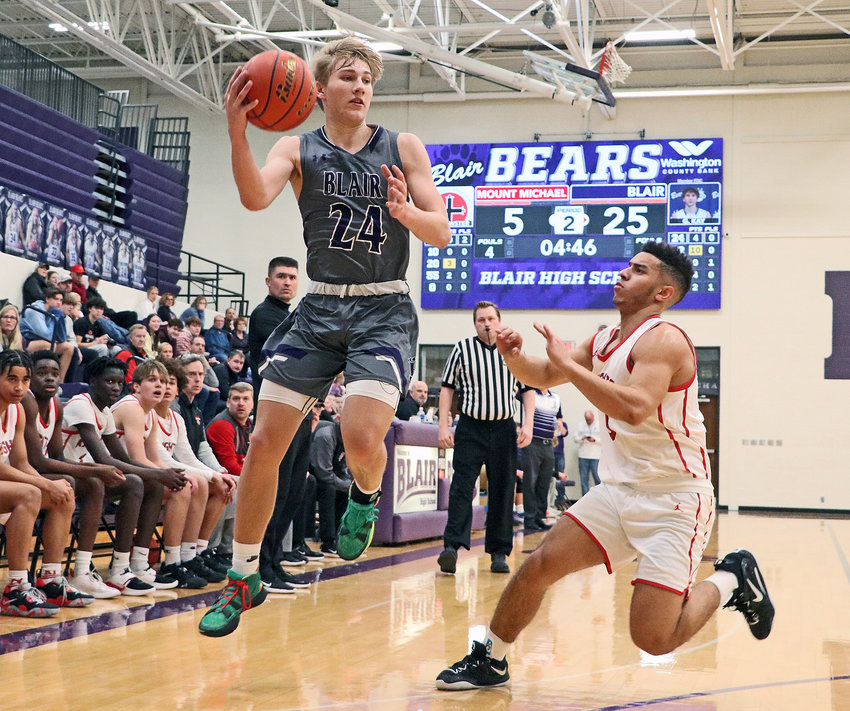 The Bears' Greyson Kay, left, hauls in a high pass against Elkhorn Mount Michael on Dec. 29 at Blair High School.