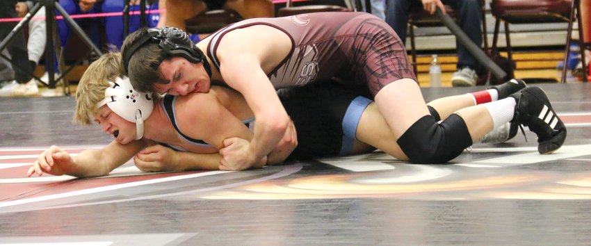Arlington's Trey Hill opens his run to a 113 pound first place finish at the Arlington Invitational Saturday with a major decision over Elkhorn North's Tyson Philbrick. .