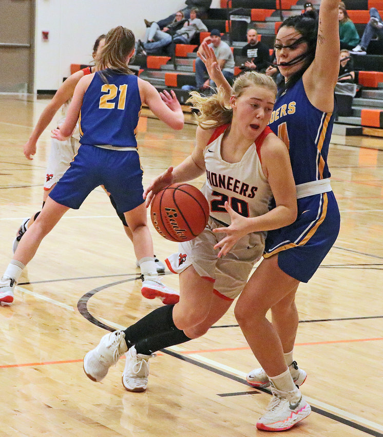 The Pioneers' Maelie Nelson, middle, drives to the basket against Logan View on Saturday at Fort Calhoun High School.