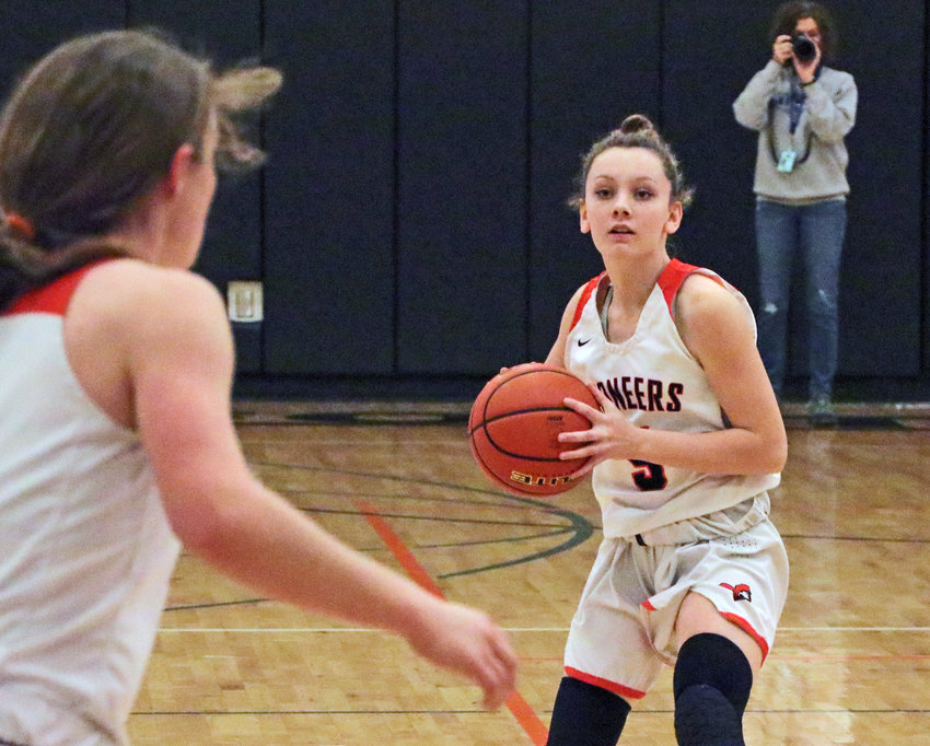The Pioneers' Izzy Greenough, right, looks ahead to pass to Kaylee Taylor on Saturday at Fort Calhoun High School.
