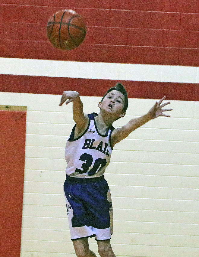 Blair fifth-grader Blayton Anderson passes the ball Saturday at Gardner-Hawks Center.