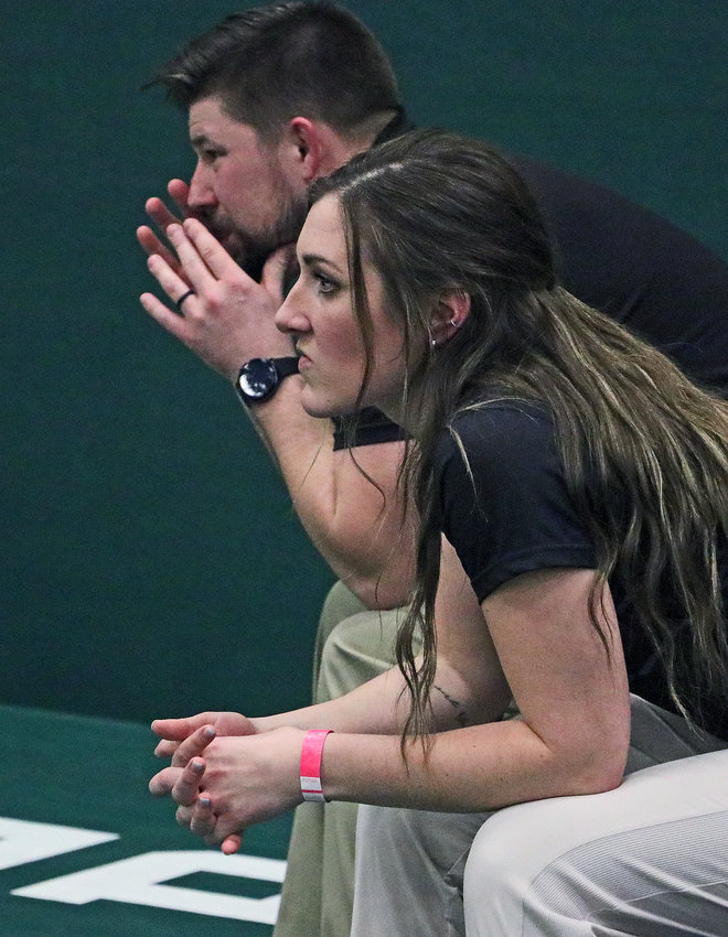 Arlington wrestling coaches Madison Wakefield, foreground, and Doug Hart watch a match Friday at Fremont High School.