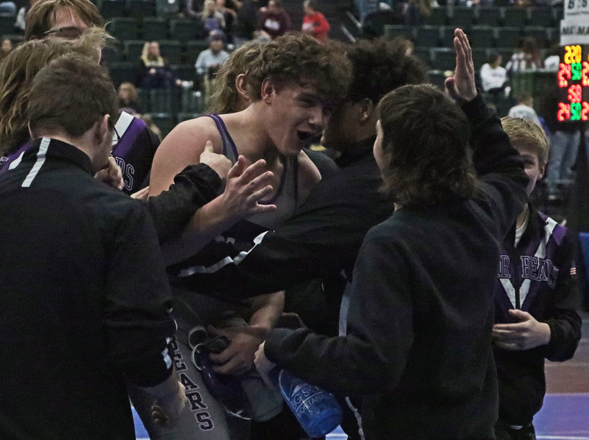 Blair wrestler Thomas Chikos, middle, celebrates a dual-winning match win against Bennington with his teammates Saturday during the NSAA State Dual Championships in Kearney. The Bears finished second to Omaha Skutt at the Buffalo County Fairgrounds.