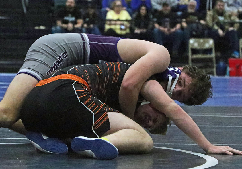 Blair 195-pounder Thomas Chikos, top, grinds out the final seconds of his dual-winning victory against Hastings' Conner Wademan on Saturday at the Buffalo County Fairgrounds.