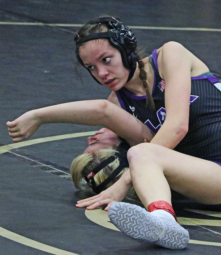Blair's Brianna Matzen, top, scores back points against the Tigers' Elliot Engel on Friday at Fremont High School.