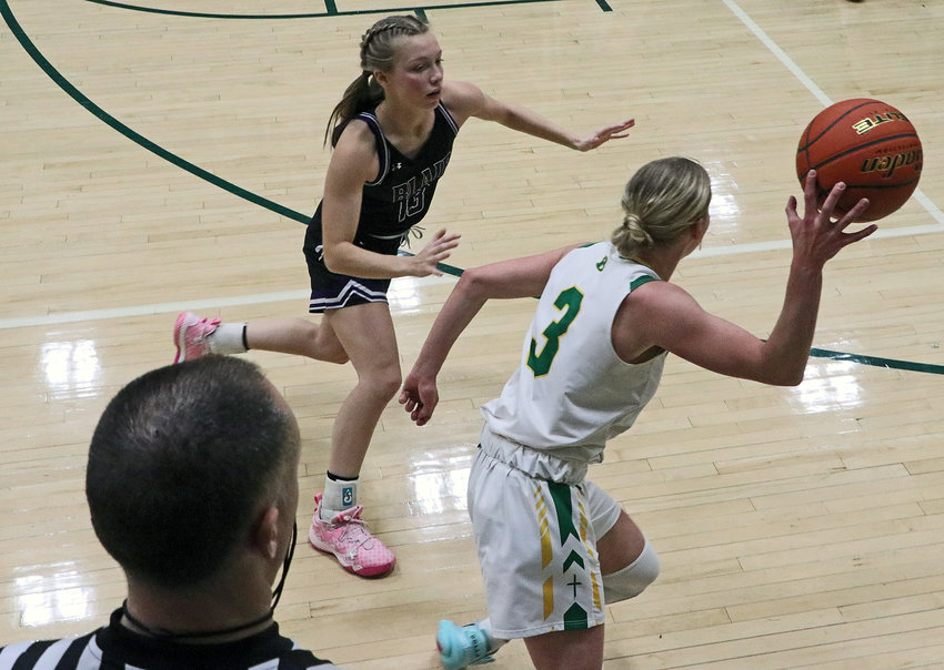 Blair junior Leah Chance, left, chases down the Knights' Kaitlyn Mlnarik as a referee watches Thursday at Fremont Bergan.