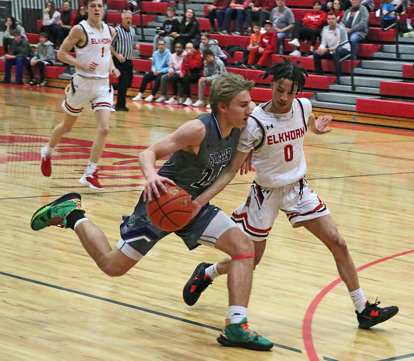 Blair's Greyson Kay, left, dribbles while defended by the Antlers' Luke Howard on Tuesday at Elkhorn High School.