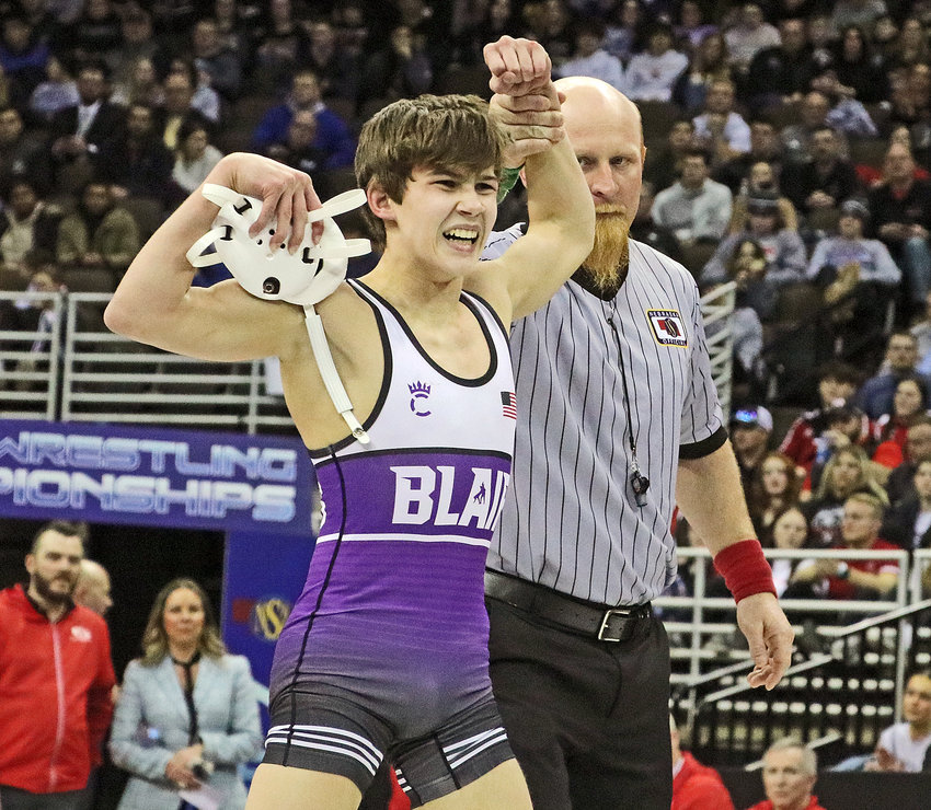Blair 106-pounder Hudson Loges flexes for the cameras Saturday after claiming at Class B state championship at the CHI Health Center in Omaha. The Bear topped former BHS teammate Cole Welte of Omaha Skutt in the final.
