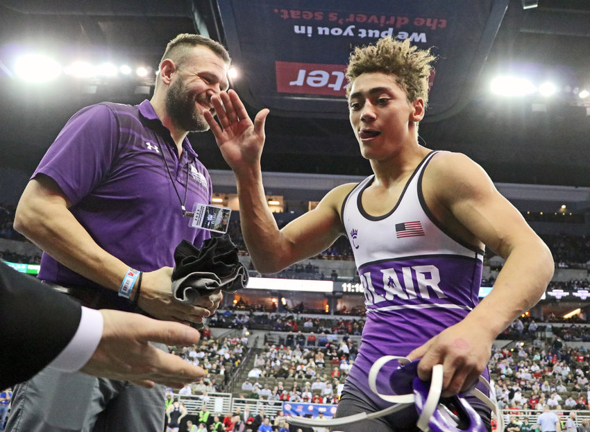 Blair 132-pounder Tyson Brown, right, comes off of the mat and celebrates a third-place win with his coaches Saturday in Omaha.