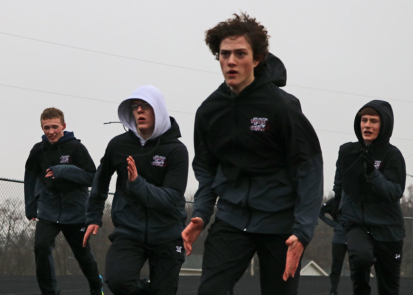 Cooper Staats, second from right, and his Eagles teammates sprint March 8 during track and field practice at Arlington High School.