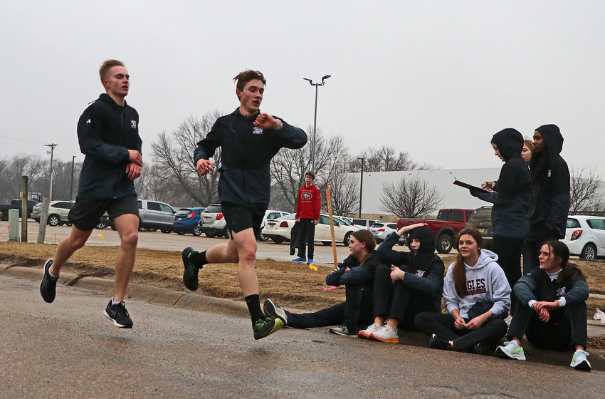 Kevin Flesner, from left, and Luke Hammang complete their run March 8 at Arlington High School.