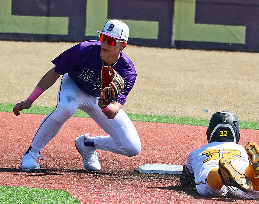 Blair infielder Greyson Kay, left, waits on a throw to second base Saturday at Bellevue West.