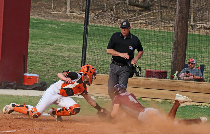 Arlington's Trevor Denker, right, slides in safe as Fort Calhoun catcher Chase Premer reaches for a tag at home plate Tuesday at the Washington County Fairgrounds.