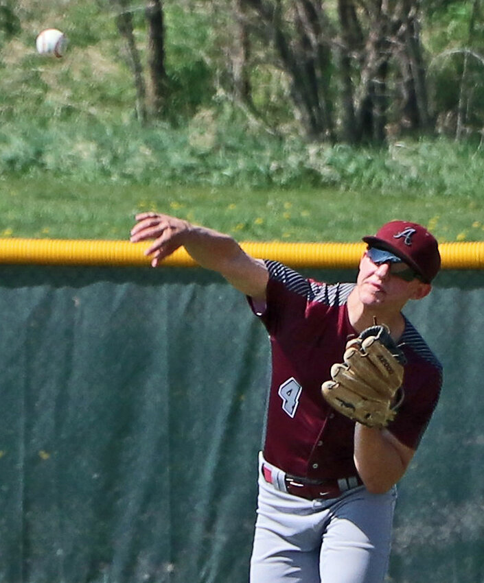 Arlington's Trevor Denker throws the ball in from right field Saturday at the Washington County Fairgrounds.