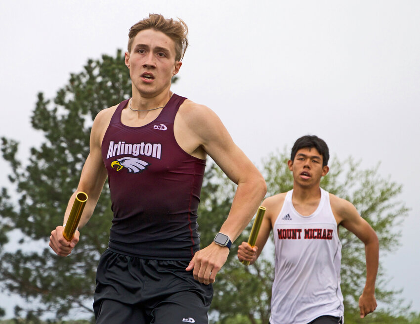 Arlington senior Luke Hammang, left, runs his leg of the 3,200-meter relay Tuesday at Elkhorn High School.