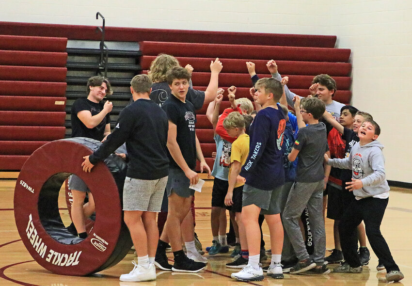 Campers and counselors break the huddle Monday at Arlington High School.
