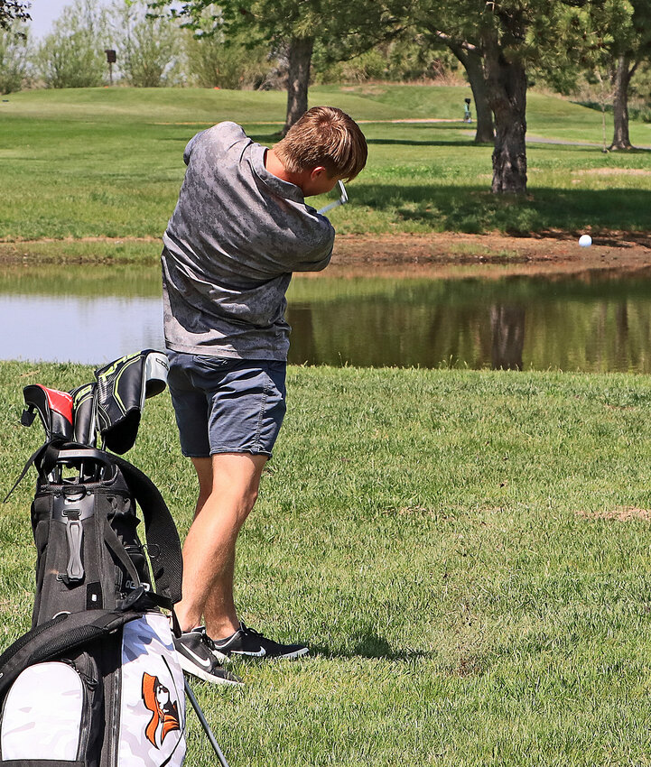Fort Calhoun's Dylan Boldt hits a hard shot over the water hazard Tuesday at Oakland Golf Club.