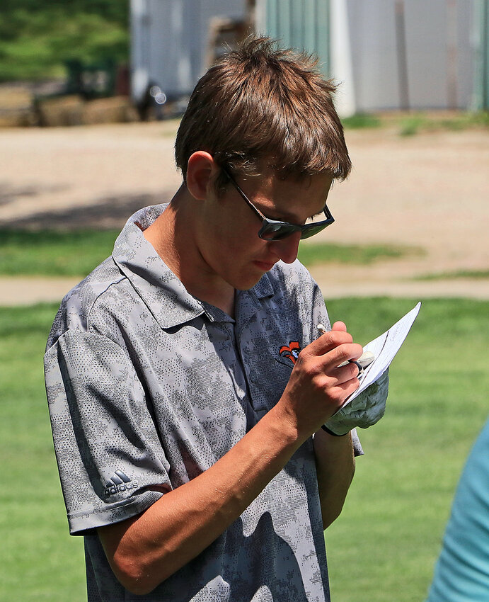 Fort Calhoun's Jayden Miller fills out his scorecard Tuesday at Oakland Golf Club.