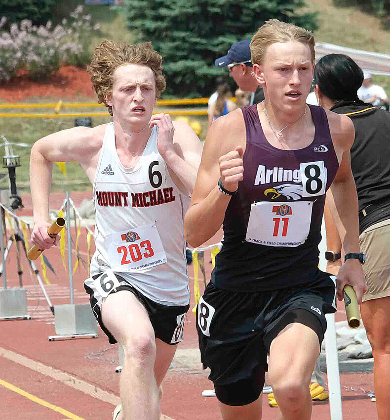 Arlington junior Nolan May, right, runs the 3,200-meter relay Wednesday at Omaha Burke Stadium.