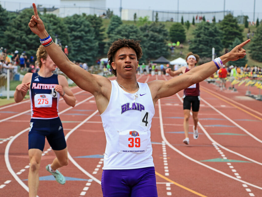 Blair sprinter Ethan Baessler celebrates winning the 100-meter dash with a state record time Thursday during the NSAA State Championships at Omaha Burke Stadium.