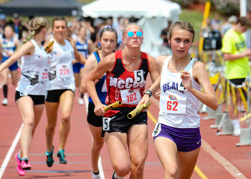 Blair's Jade Wickwire, right, runs the 3,200-meter relay Wednesday at Omaha Burke Stadium.
